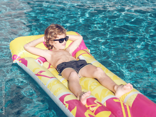 Cheerful boy on inflatable float photo