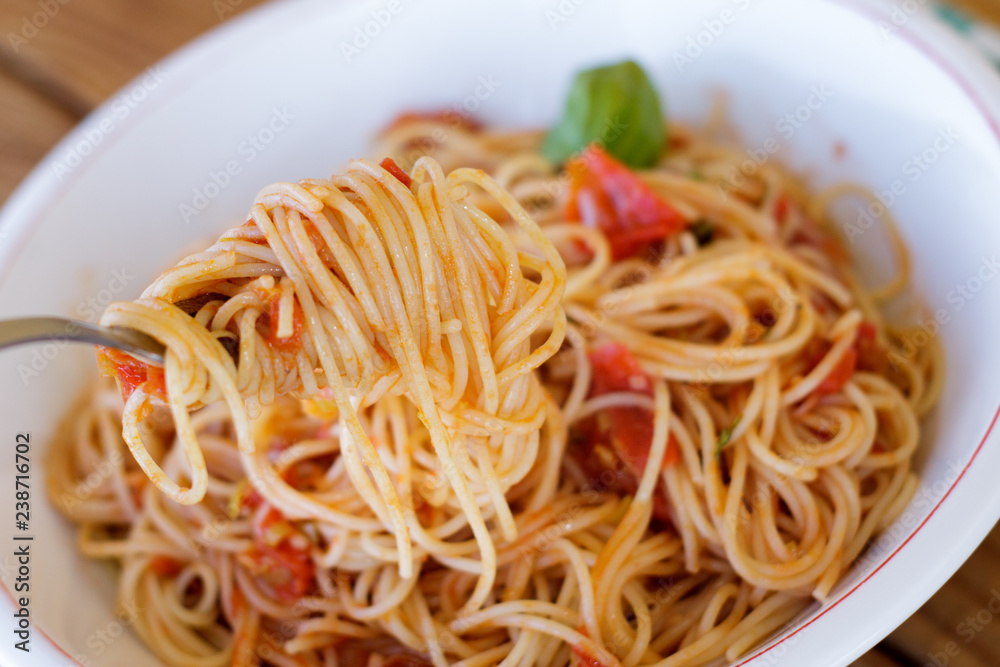 Eating spaghetti napolitain with selective focus Eating spaghetti napolitain with selective focus