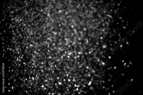 Falling snow on a black background. Snowfall weather. Texture for overlay