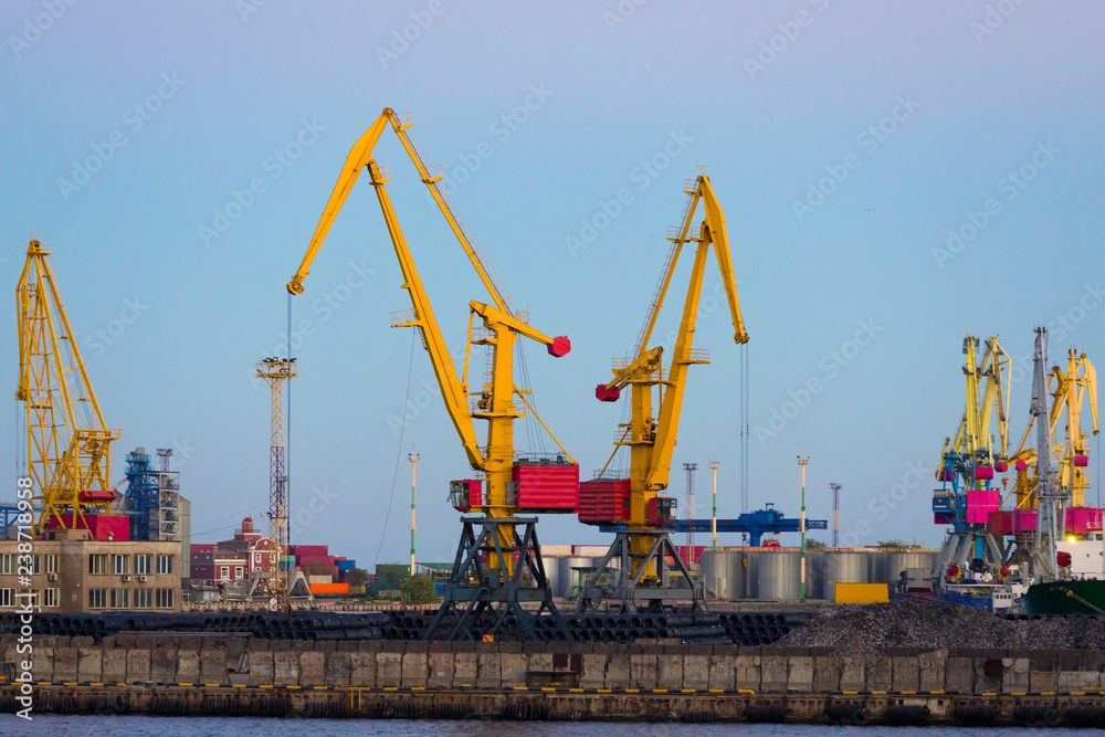 Cargo port cranes on a background of blue sky