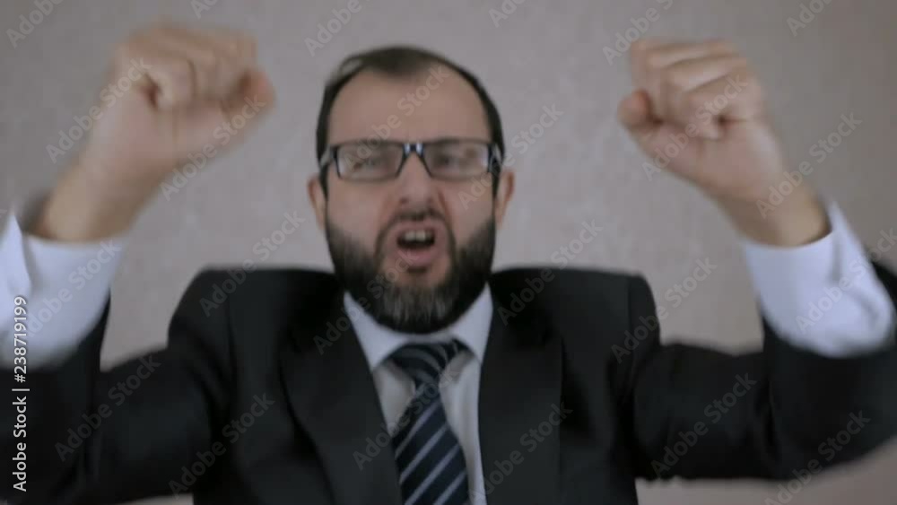 Closeup portrait of happy man surprised. Positive human emotion Successful clerk. Manager is happy luck. Emotional man in office. Attractive man with a beard dancing in office. Slow motion. Closeup portrait of happy man surprised. Positive human emotion Successful clerk. Manager is happy luck. Emotional man in office. Attractive man with a beard dancing in office. Slow motion.