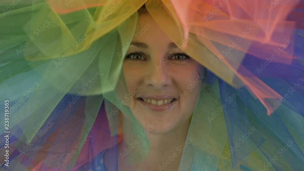 Indoors portrait of amazing caucasian female model in trendy colorful wig woman with hair having fun smiling. Young beautiful woman in a rainbow wig LGBT.. Indoors portrait of amazing caucasian female model in trendy colorful wig woman with hair having fun smiling. Young beautiful woman in a rainbow wig LGBT..