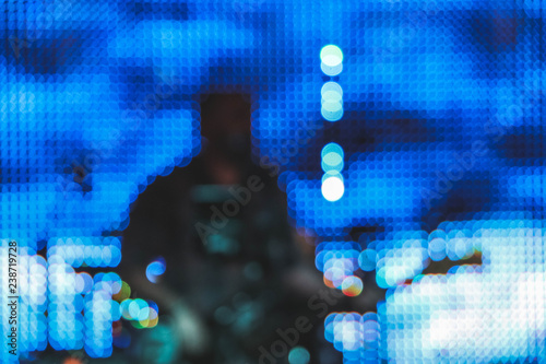 Blurred silhouette of the artist singer with a guitar on a scene. Abstract rock concert concept performance  blur background.