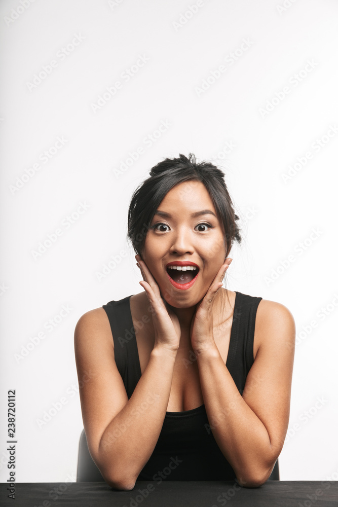 Pretty young asian woman sitting at the table Pretty young asian woman sitting at the table