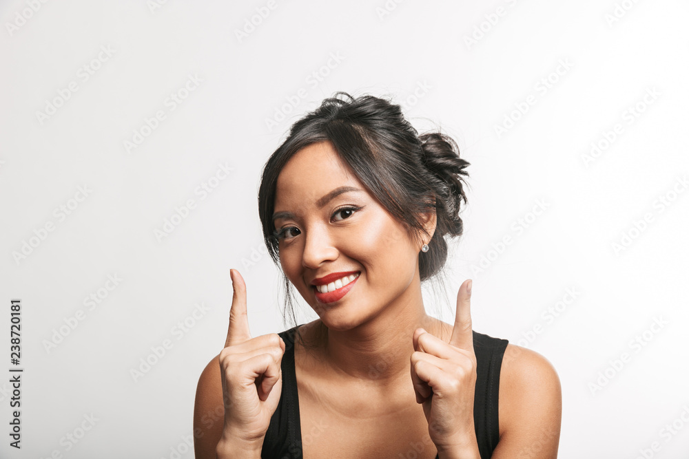 Pretty young asian woman sitting at the table Pretty young asian woman sitting at the table