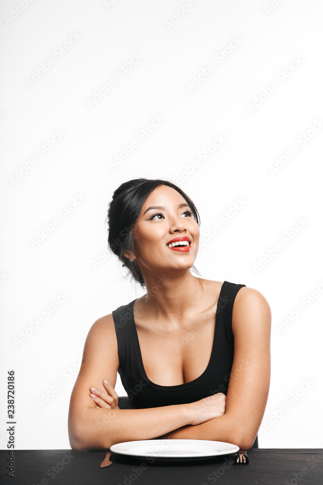 Pretty asian woman sitting at the table Pretty asian woman sitting at the table