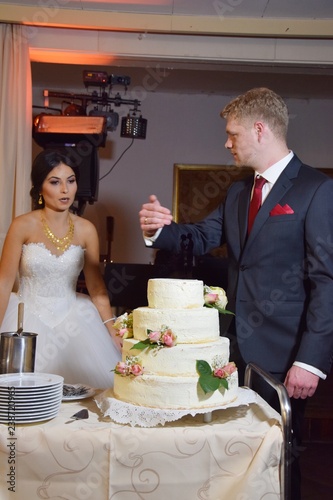 Braut und Bräutigam füttern sich gegenseitig mit einem Stück Hochzeitstorte