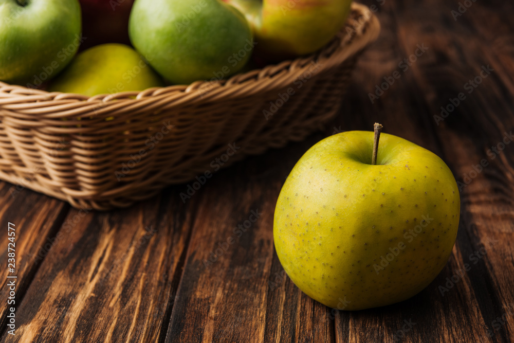 golden delicious apple with fruit wicker basket at background
