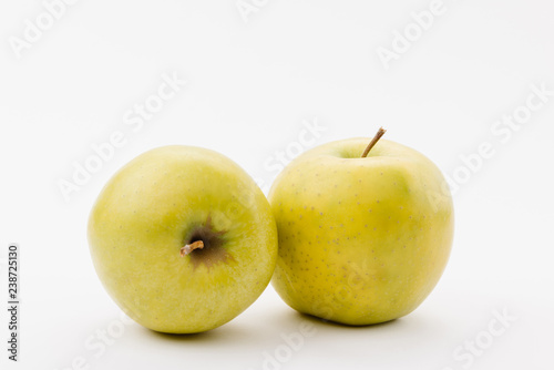 ripe golden delicious apples on white background