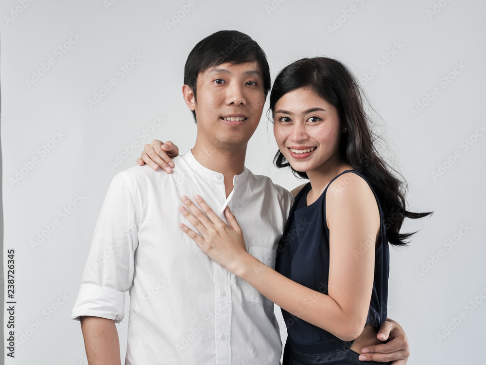 Asian couple hugging together with white background. Asian couple hugging together with white background.