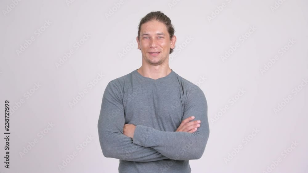 Happy handsome man smiling with arms crossed