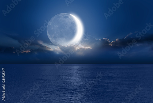 Night sky with moon in the clouds  Elements of this image furnished by NASA