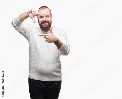 Young caucasian hipster man wearing winter sweater over isolated background smiling making frame with hands and fingers with happy face. Creativity and photography concept.
