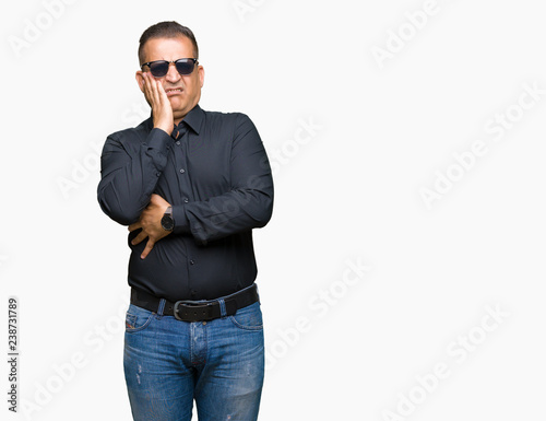 Middle age arab man wearing sunglasses over isolated background thinking looking tired and bored with depression problems with crossed arms.