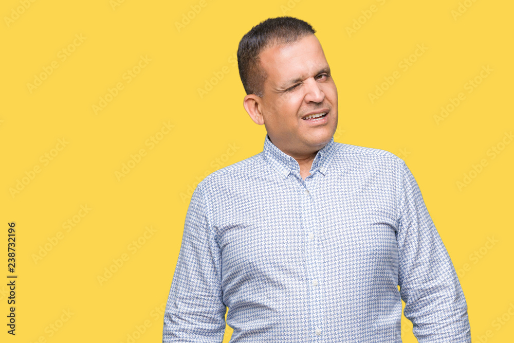 Middle age arab business man over isolated background winking looking at the camera with sexy expression, cheerful and happy face. Middle age arab business man over isolated background winking looking at the camera with sexy expression, cheerful and happy face.