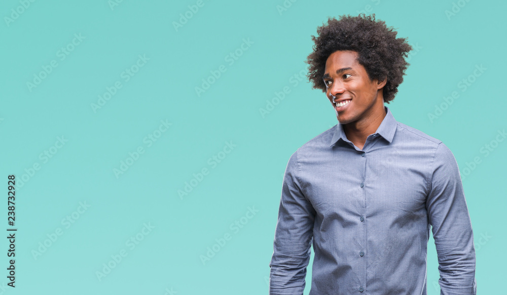 Obraz premium Afro american man over isolated background looking away to side with smile on face, natural expression. Laughing confident.