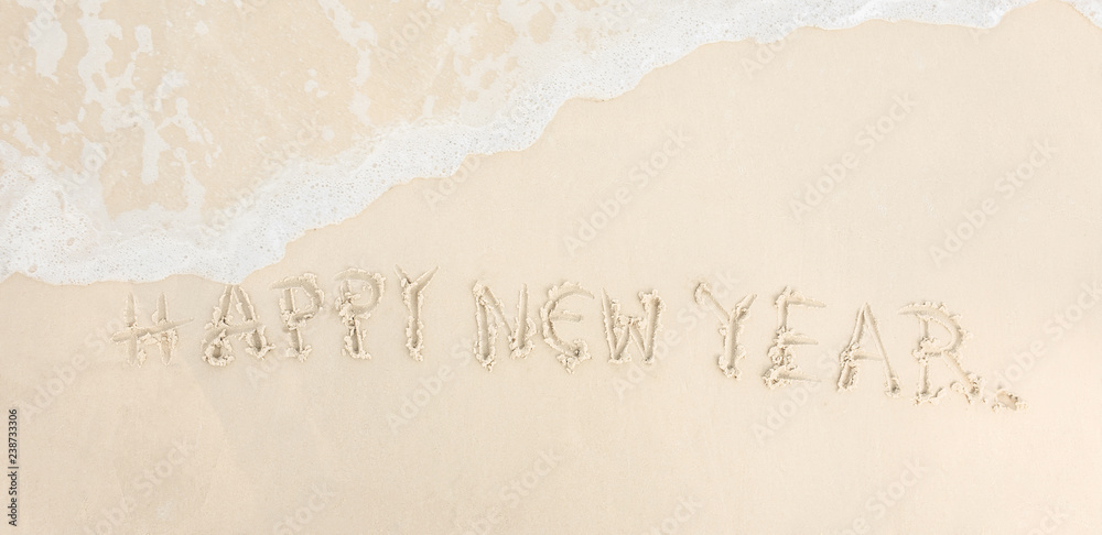 Happy New year 2019 Written on sand white wave the sea Travel and vacations Celebration Shoot photo by smart phone