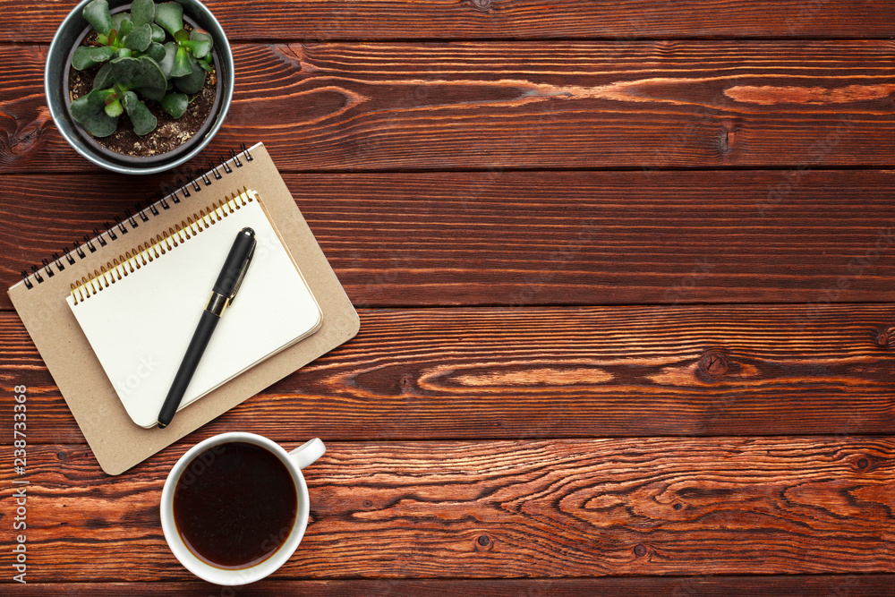 Office supplies and equipment on dark wooden table, top view