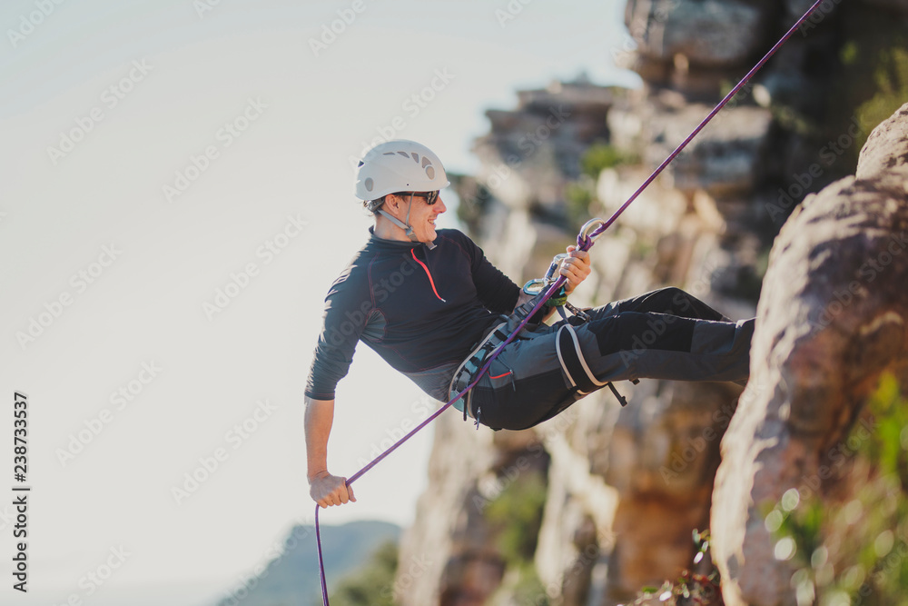 Man climbing mountain on sunny day Man climbing mountain on sunny day