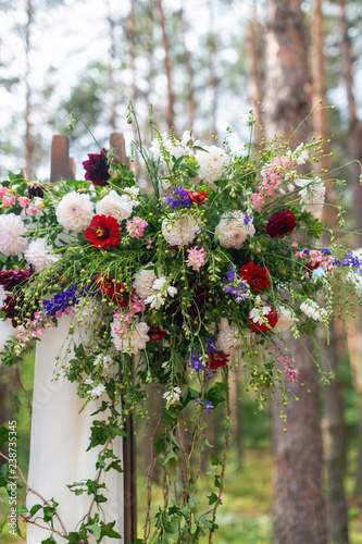 Wedding arch decorated with flowers outdoors. Beautiful wedding set up. Modern wedding in the summer