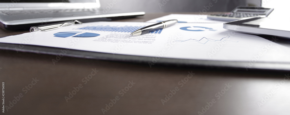 close up. financial chart and laptop on desktop close up. financial chart and laptop on desktop