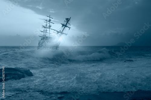 Sailing old ship in storm sea against amazing sunset © muratart