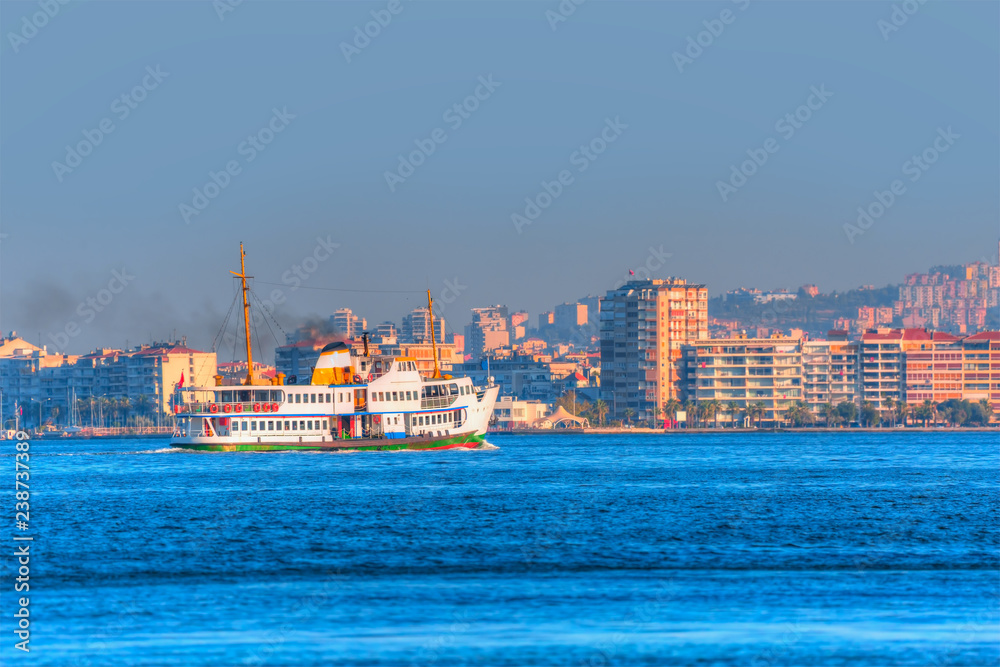 Izmir ferry services in the Gulf of Izmir at sunset - Cityscape of Karsiyaka Izmir, Turkey