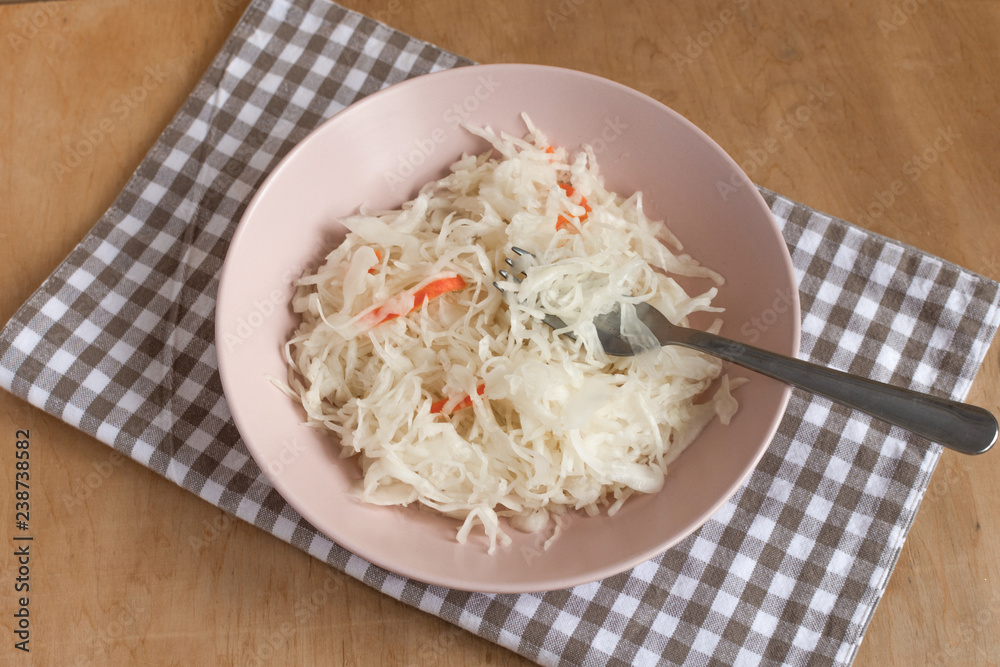 Pickled cabbage in a bowl on table top view. Fermented vegetables. Pickled cabbage in a bowl on table top view. Fermented vegetables.