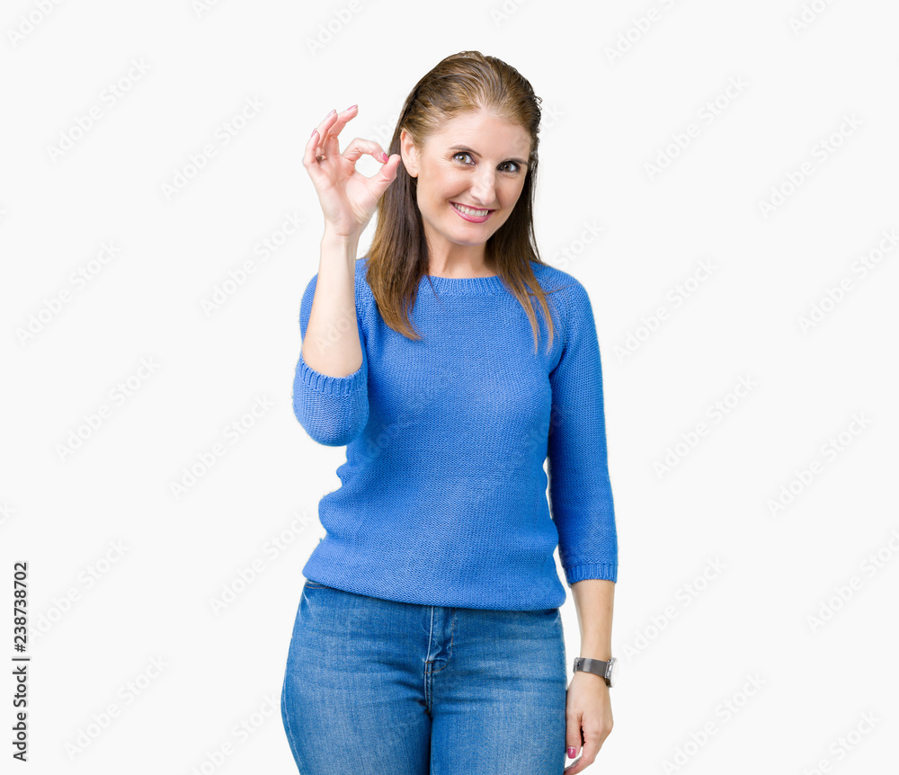 Beautiful middle age mature woman wearing winter sweater over isolated background smiling positive doing ok sign with hand and fingers. Successful expression. Beautiful middle age mature woman wearing winter sweater over isolated background smiling positive doing ok sign with hand and fingers. Successful expression.