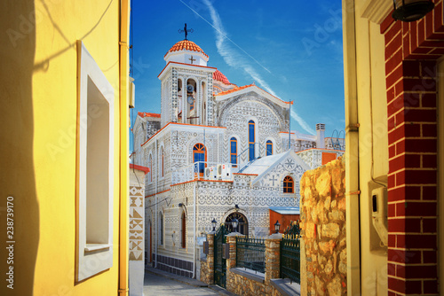    Mediterranean Greek Island Chios: Beautiful traditional ornamented church Pyrgi town with yellow colored walls of greek house buildings  photo