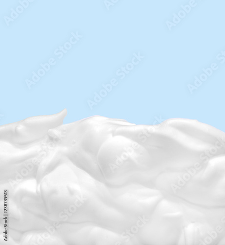 Gentle white cosmetic cream on blue background.