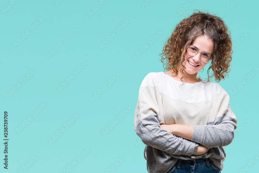 Beautiful brunette curly hair young girl wearing glasses over isolated background happy face smiling with crossed arms looking at the camera. Positive person. Beautiful brunette curly hair young girl wearing glasses over isolated background happy face smiling with crossed arms looking at the camera. Positive person.
