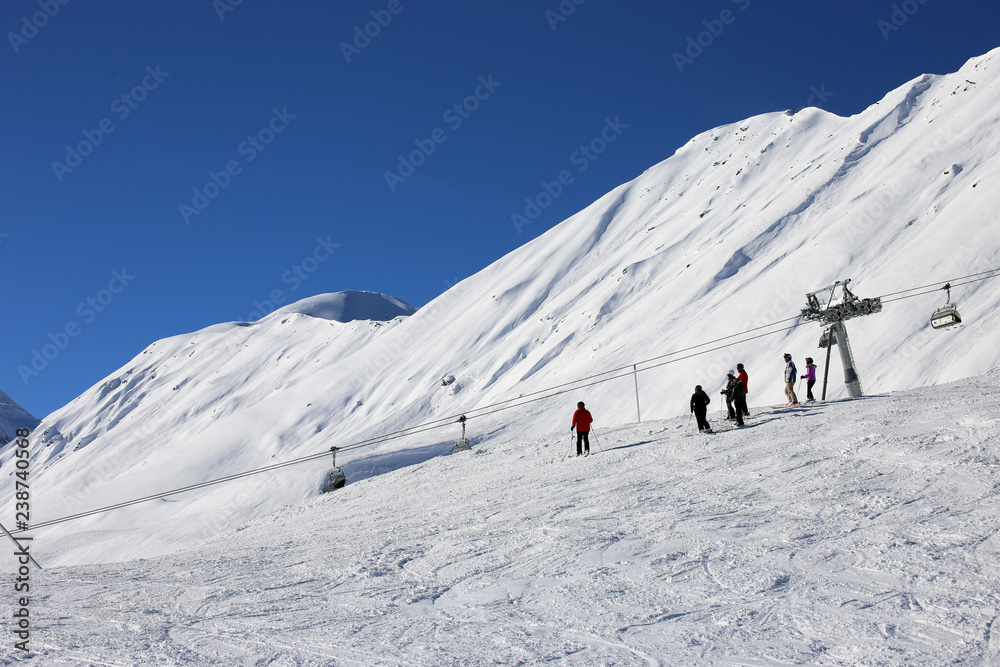 Skiers riding the slope