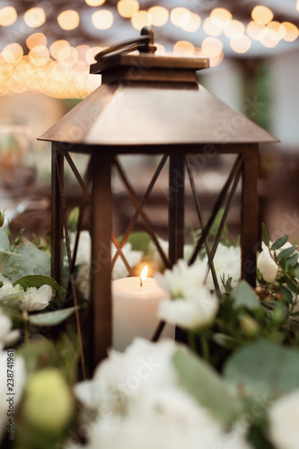 Candle in the lantern. Beautiful flower decorations with candles for the wedding ceremony.