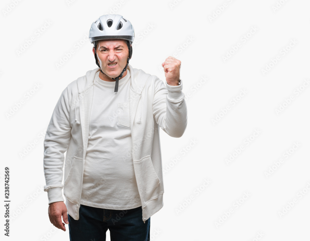 Handsome senior cyclist man wearing bike helmet over isolated background annoyed and frustrated shouting with anger, crazy and yelling with raised hand, anger concept Handsome senior cyclist man wearing bike helmet over isolated background annoyed and frustrated shouting with anger, crazy and yelling with raised hand, anger concept