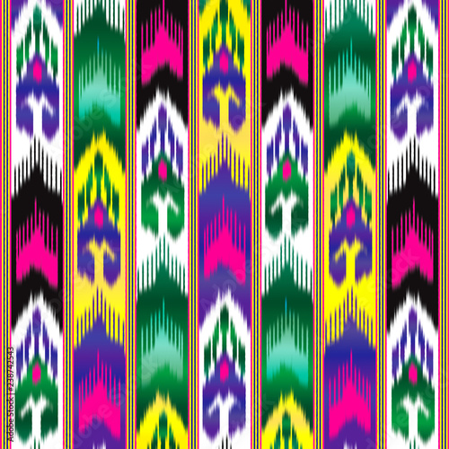 Ikat is Asian silk material. Fabric adras, Uzbek national pattern. Colorful background. photo