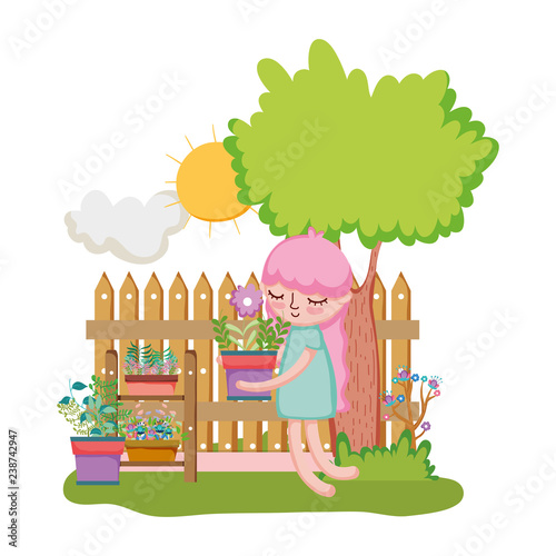 little girl lifting houseplant with fence and tree