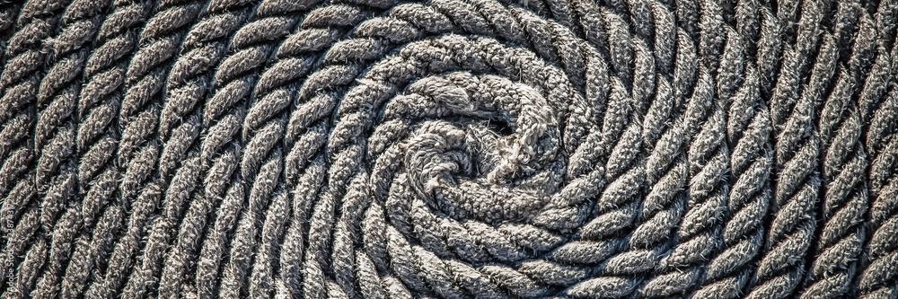 The rope for the boat laid in the form of a spiral. Background. The rope for the boat laid in the form of a spiral. Background.