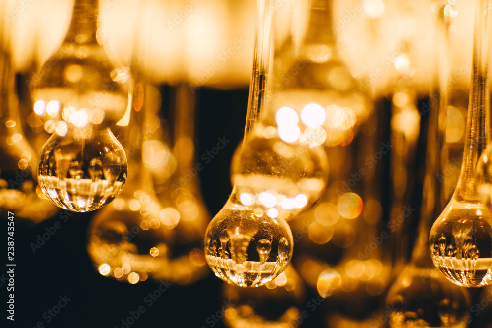 abstract blurry glowing lights of a crystal lamp. Warm light glass. abstract blurry glowing lights of a crystal lamp. Warm light glass.
