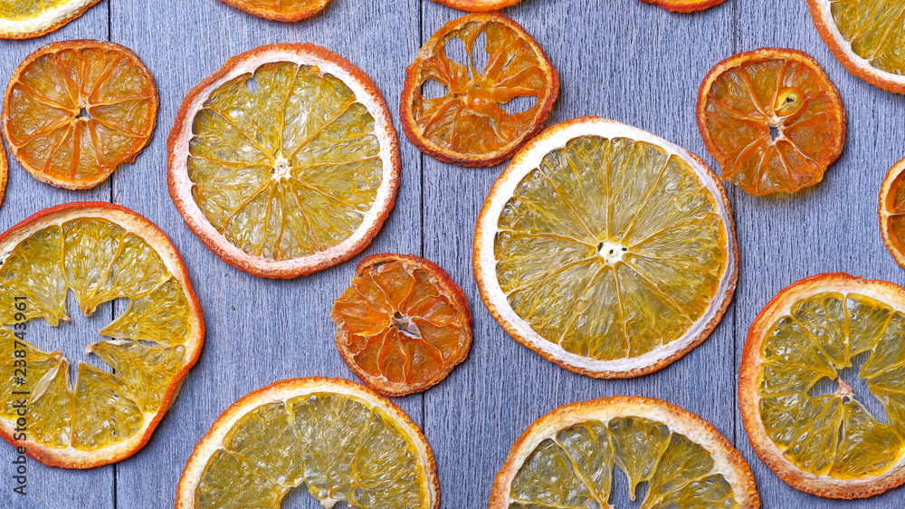 Dried orange slices on gray wooden background
