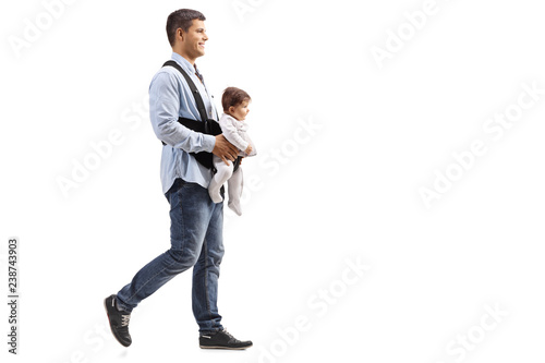 Father walking with a baby in carrier