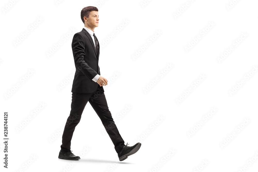 Young handsome man in a black suit walking Young handsome man in a black suit walking