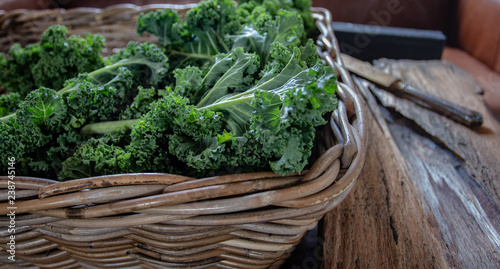 Kale on wooden background on daylight superfood vegetables