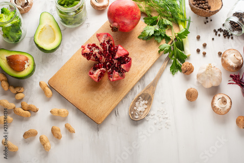 Vegan food, detox, avocado, fruit, green beans, broccoli, nuts and mushrooms. Diet and healthy food, vitamins and sports. Flat-lay clean food,dieting breakfast food concept on white background