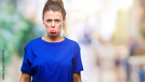 Young beautiful woman wearing casual blue t-shirt over isolated background depressed and worry for distress, crying angry and afraid. Sad expression.