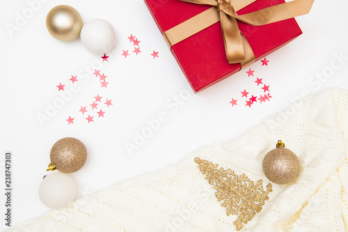 Christmas composition. Gift, red and gold decorations on white background. Christmas, winter, new year concept. Flat lay, top view, copy space