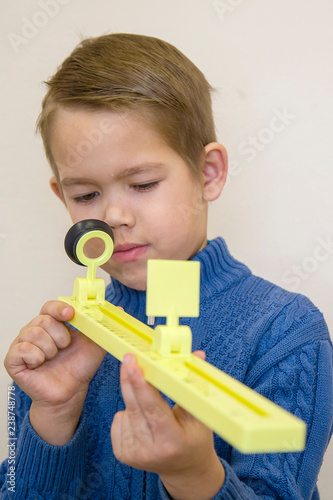 boyboy holds a ruler for measuring vision holds a ruler for measuring vision photo