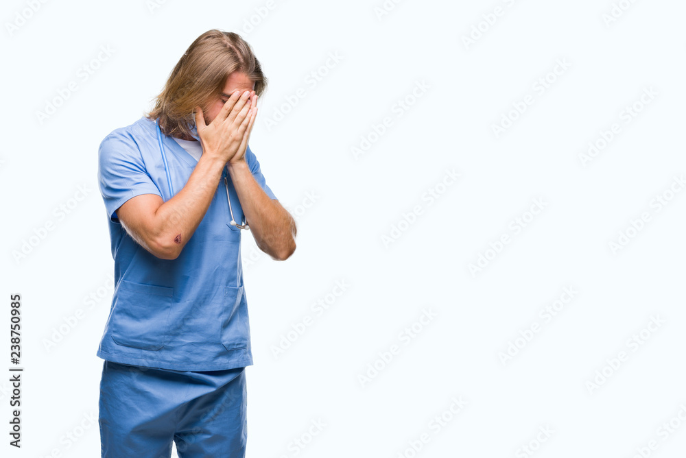 Young handsome doctor man with long hair over isolated background with sad expression covering face with hands while crying. Depression concept. Young handsome doctor man with long hair over isolated background with sad expression covering face with hands while crying. Depression concept.