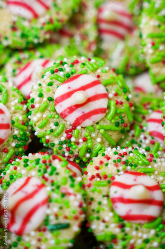 White chocolate peppermint kisses cookies decorated with Christmas holiday sprinkles and jimmies. Portrait orientation
