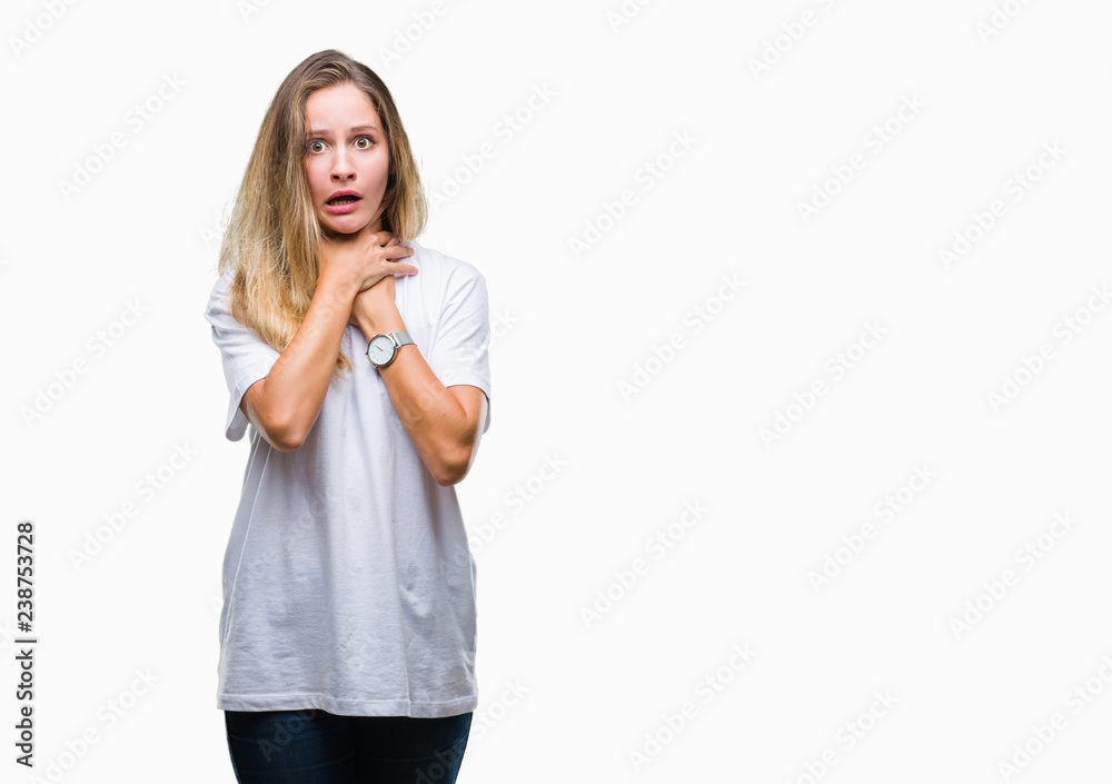 Young beautiful blonde woman wearing casual white t-shirt over isolated background shouting and suffocate because painful strangle. Health problem. Asphyxiate and suicide concept. Young beautiful blonde woman wearing casual white t-shirt over isolated background shouting and suffocate because painful strangle. Health problem. Asphyxiate and suicide concept.